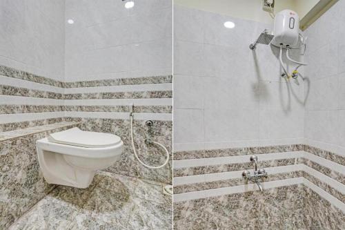 a bathroom with a toilet and a shower at hotel orange palace in Surat