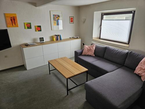 a living room with a couch and a table at Ferienhaus Welling in Welling
