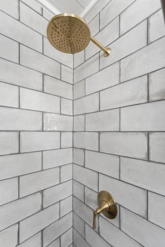 a bathroom with a shower with white subway tiles at Cedar Break at Howard Ranch in Driftwood
