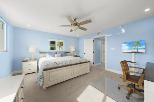 a blue bedroom with a bed and a ceiling fan at Island Beach Club #360D in Sanibel