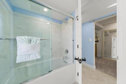 a bathroom with a shower and a glass door at Island Beach Club #360D in Sanibel