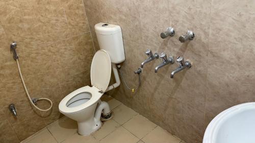 a bathroom with a toilet and a shower at VISHNOO STAYS Sunny Morning Room in Nawāgaon