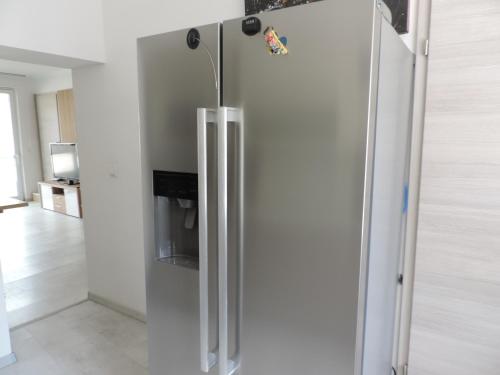 a stainless steel refrigerator in a kitchen at Ferienwohnung Anita in Rust