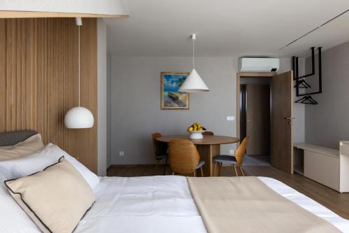 a hotel room with a bed and a table at Horizon 180 in Varna City