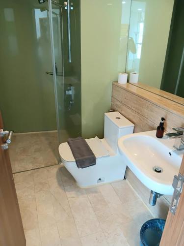 a bathroom with a shower and a toilet and a sink at Vortex suites klcc by kl cozy home in Kuala Lumpur