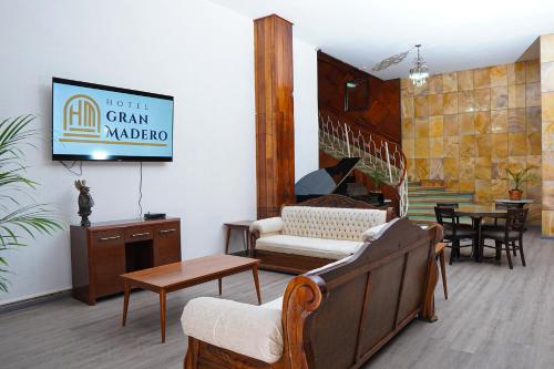 a living room with a couch and a table at Hotel GranMadero in Durango