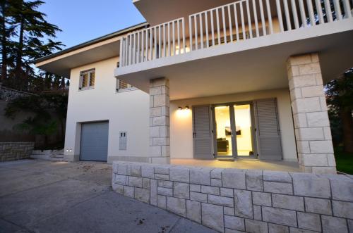 a house with a staircase on the side of it at Forgotten Garden Villa in Portorož