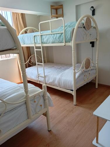 a room with two bunk beds and a chair at villa hermosa cayma in Yanahuara