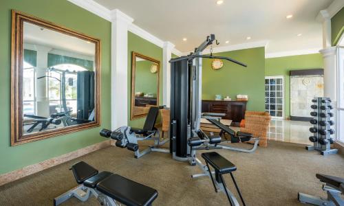 a gym with several exercise bikes and a mirror at Quinta Edén Villahermosa in Villahermosa