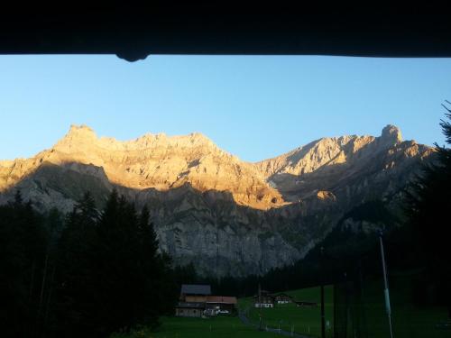 a view of a mountain from a window at Chalet Bunderbach in Adelboden