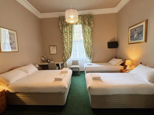 a room with two beds and a living room at Hanover House in Edinburgh