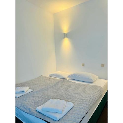 a bedroom with a bed with two towels on it at Hotel pod Dębem in Szydłowiec