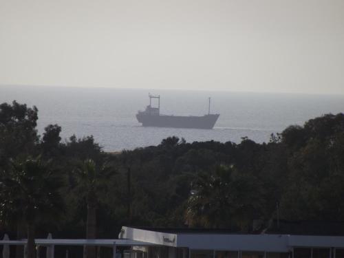 a large ship floating in the ocean on the water at Kefalonitis Hotel Apartments in Paphos City