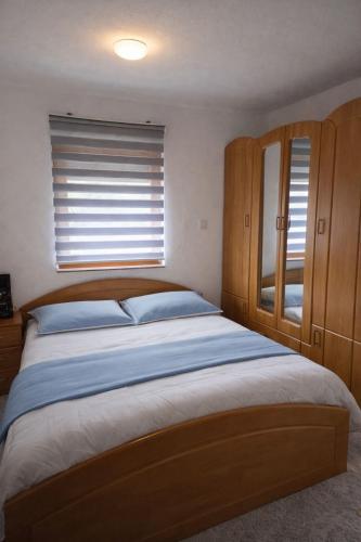 a bedroom with a large bed and a window at Edi in Sarajevo
