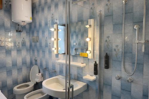 a bathroom with a toilet and a sink and a shower at Villa Riviera by the Sea in Lignano Sabbiadoro