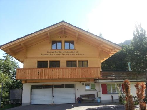 a house with a gambrel roof with two garage at Bunderbach in Adelboden