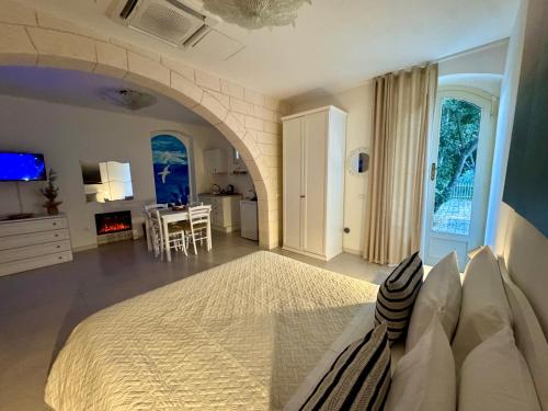 a large bedroom with a bed and a living room at Lamapulia in Torre a Mare