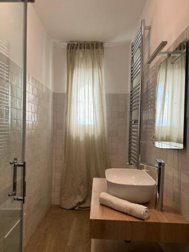 a white bathroom with a sink and a shower at Mare guest house in Termoli