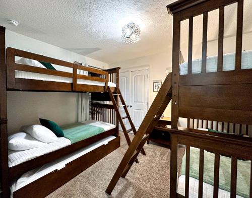 a bedroom with two bunk beds and a ladder at 6 Bedrooms 5.5 Bathrooms Solterra 4193 OD in Orlando