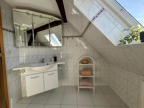 a bathroom with a sink and a mirror at Ferienwohnung Insel Malchow mit eigenem Bootsanleger in Malchow