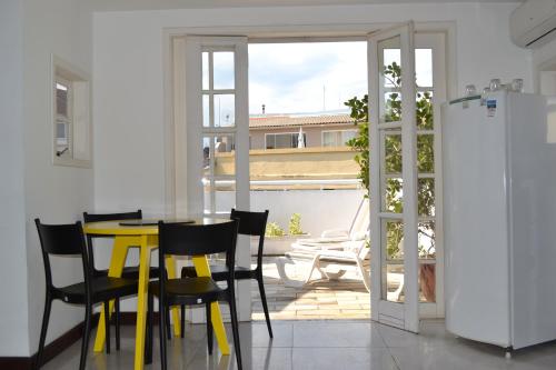 comedor con mesa amarilla y sillas en Roxy Apartments en Río de Janeiro