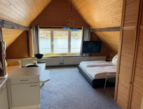 a bedroom with a bed and a television in a room at Ferienwohnung Insel Malchow mit eigenem Bootsanleger in Malchow