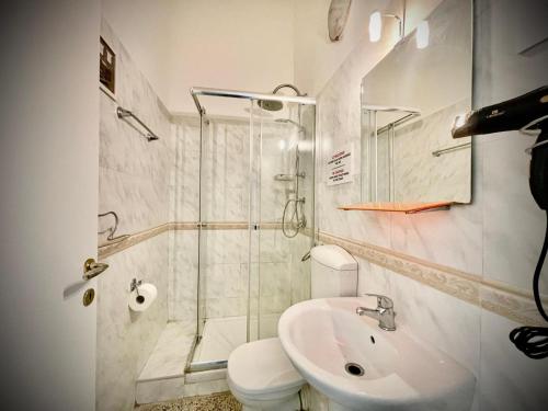 a bathroom with a shower and a toilet and a sink at B&B Resto al Sud 2 in Salerno