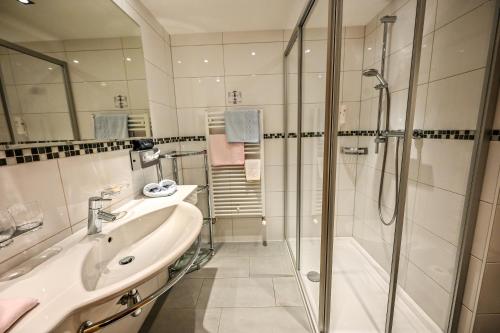 a bathroom with a sink and a shower at Pension Berger in Oberlech