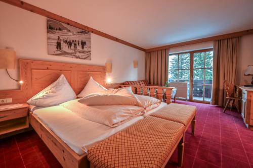 a bedroom with a large bed in a room at Pension Berger in Oberlech