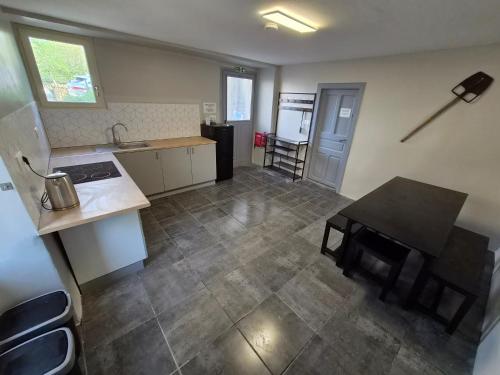 a kitchen with a table and a kitchen with a table and chairs at 16 Chemin De Compostelle in Sénergues