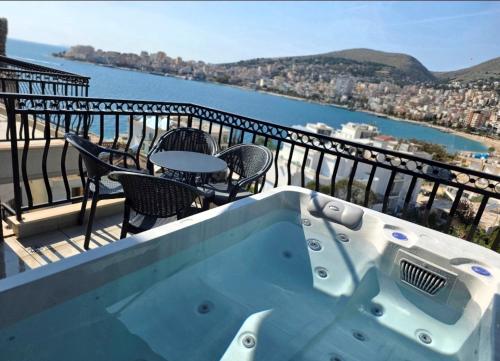 a hot tub on a balcony with a view of the water at Duplex Penthouse with Jacuzzi in Sarandë