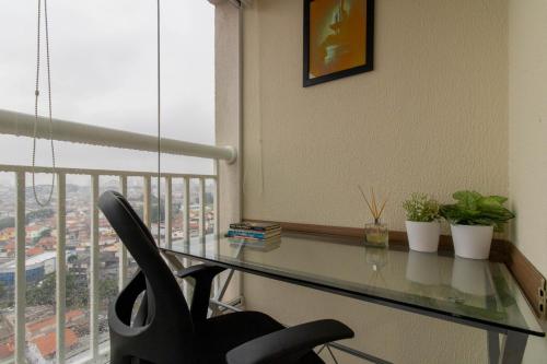 a glass desk with a chair in front of a window at Lovely Studio - GRU 1613 in Guarulhos
