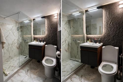 a bathroom with two toilets and a sink and mirrors at Kjara's Nest in Neoi Epivates