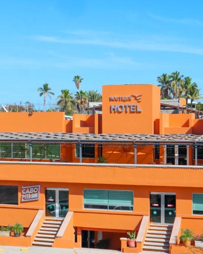 an orange hotel with a sign on top of it at Hotel Boutique Plaza Doradas in San José del Cabo