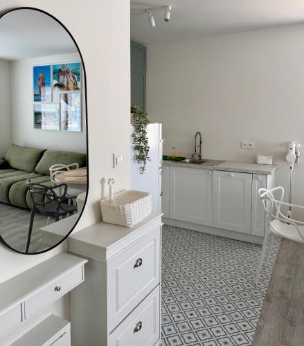 a kitchen with a mirror and a living room at Wydmowa Ostoja in Żarnowska