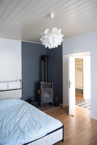 a bedroom with a bed and a fireplace at Pim's in Steffeln