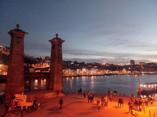 a group of people standing near a body of water at Oporto Central Flat in Porto