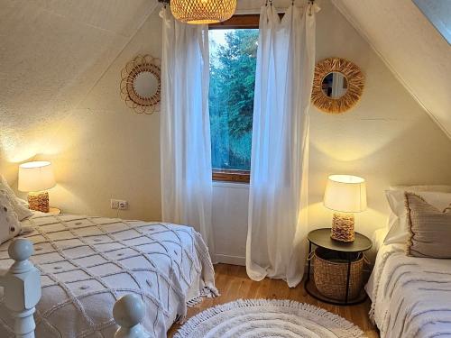 a bedroom with a bed and a window at Pond View Cabin in Būda