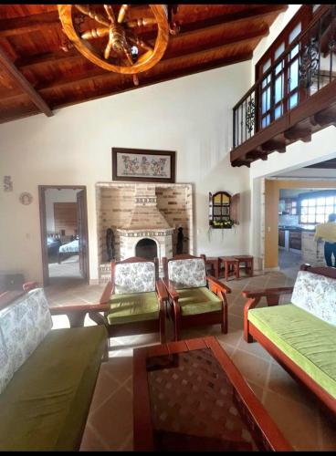 a living room with couches and a fireplace at La Mona in Calima