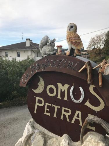 a sign with stuffed animals sitting on top of it at Domus Petrae in Ripatransone