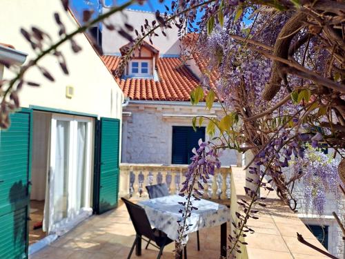 a table and chairs on the patio of a house at Medulić Palace Rooms & Apartments in Šibenik