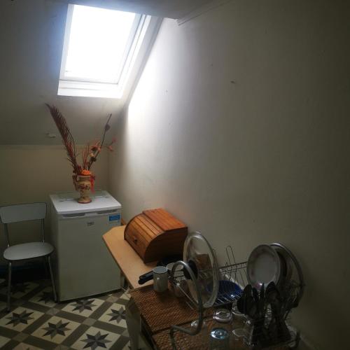 a kitchen with a sink and a window and a table at Trapmouse hostel in Brussels