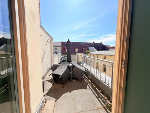 a view from a window of a balcony with a bench at Amaroo - Serviced Apartments "Branden" in Potsdam