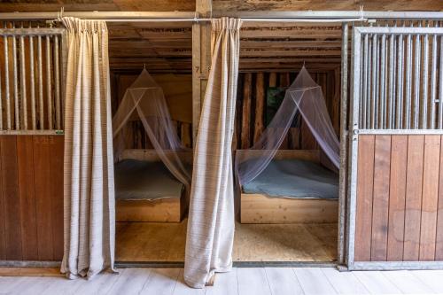 two bunk beds in a room with curtains at Back to Basic in Zwaanshoek