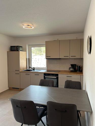 a kitchen with a table and chairs in it at Seebrise in Geeste
