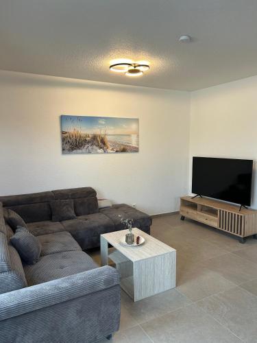 a living room with a couch and a flat screen tv at Seebrise in Geeste