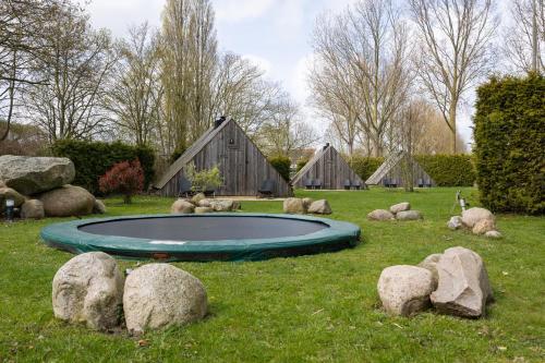 a small pool in the middle of a field with rocks at Back to Basic in Zwaanshoek