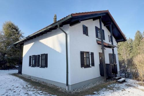 a white house with black shuttered windows on it at Nalas Auszeit in Regen