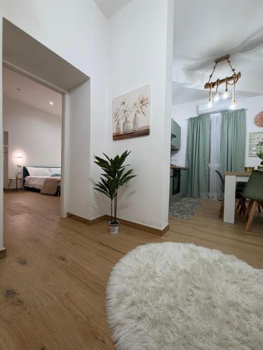 a white living room with a white rug and a table at Casa Arco Varano in Crotone
