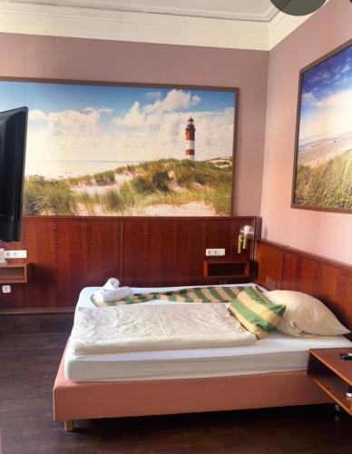 a bedroom with a bed with a picture of a lighthouse at Stilbruch Glückstadt in Glückstadt